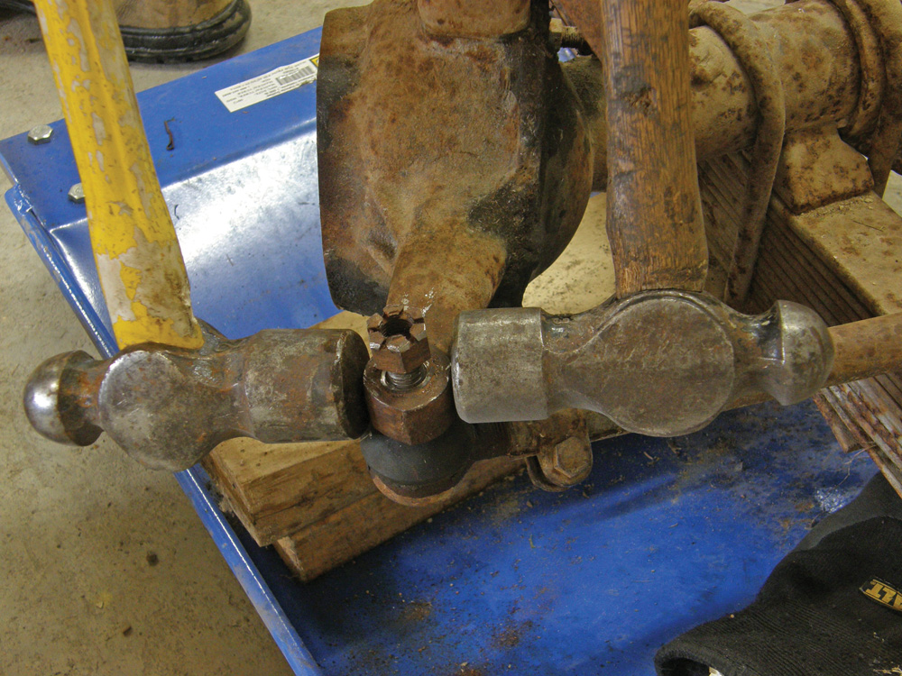 To pop tie rod ends loose, strike the joint on opposite sides simultaneously with a pair of hammers.