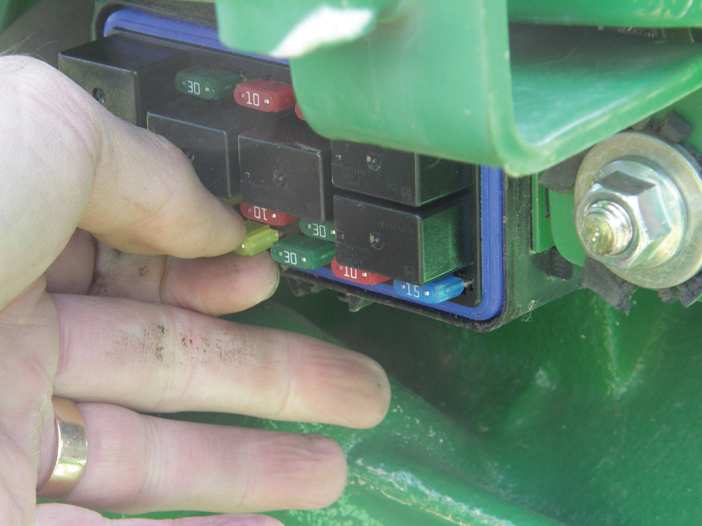 Removing one fuse at a time until the current flow stopped revealed which circuit had the faulty component.