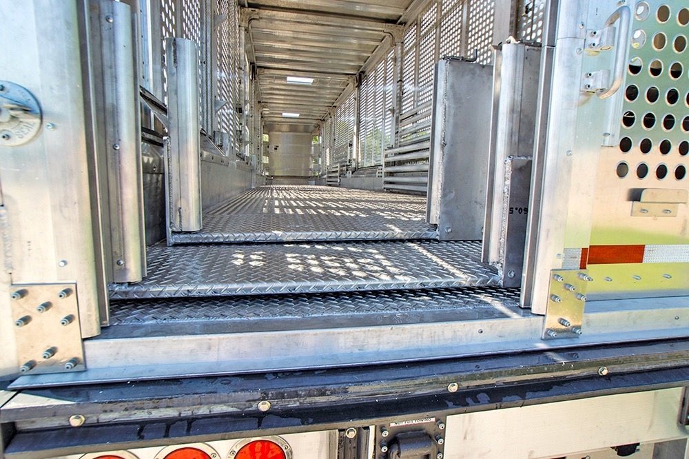 A new trailer design enables livestock to walk into transport trailers on a flat surface, which is said to reduce animal stress, fatigue and injury.
