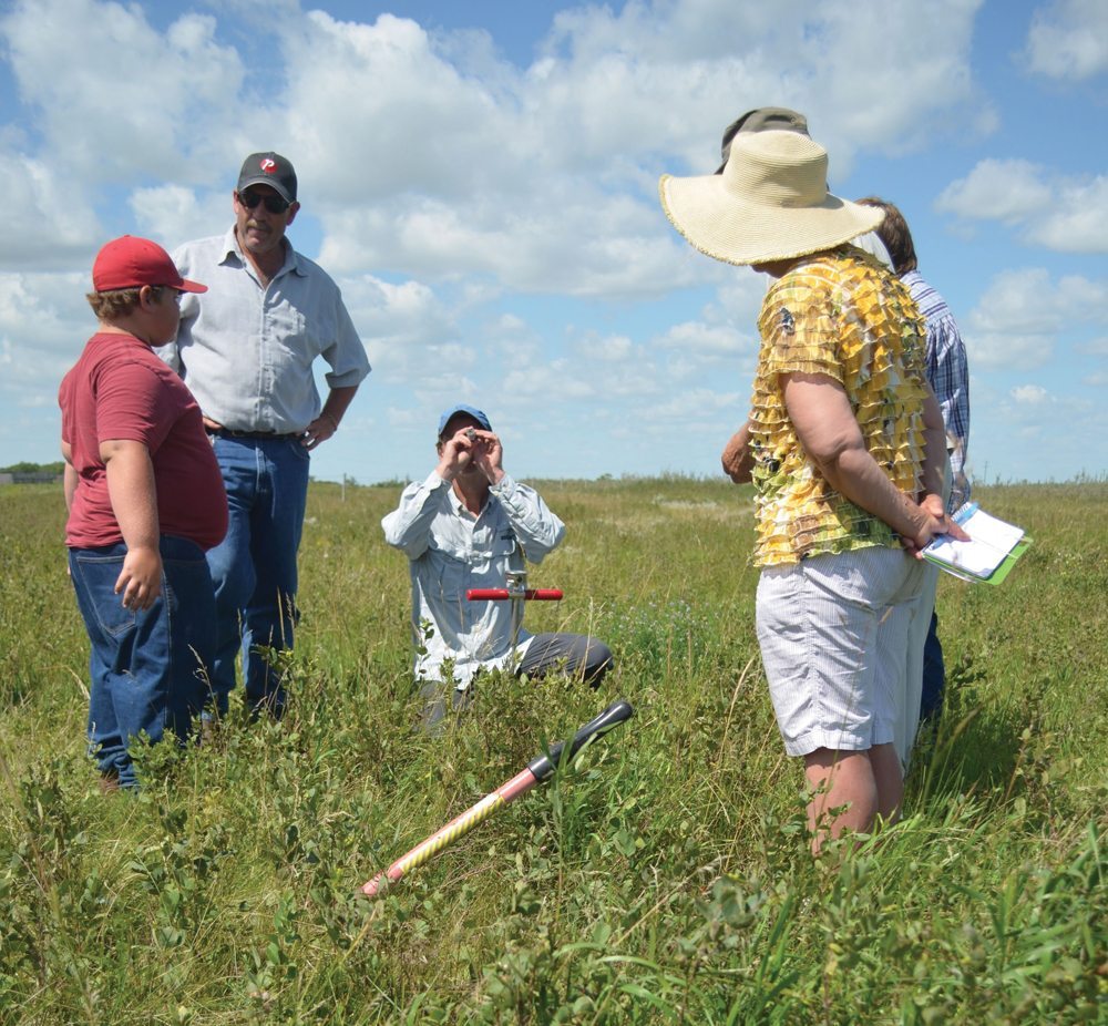 Manitoba grazing club co-ordinator Michael Thiele tests sugar levels with a refractometer during the grazing workshop.
