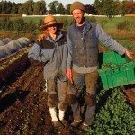 Man and woman standing in a garden.