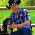 Man wearing cowboy hat petting a dog.