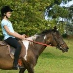 young girl riding pony