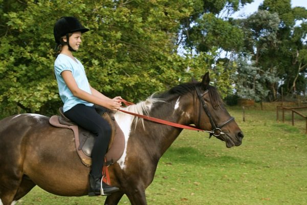 young girl riding pony
