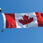 Canada flag on a background of blue sky.