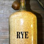 Rye grain stored in a labeled container.