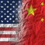 American and Chinese flags on crumpled paper, diplomatic crisis