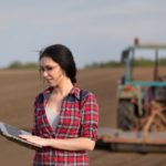 farmer with laptop in field