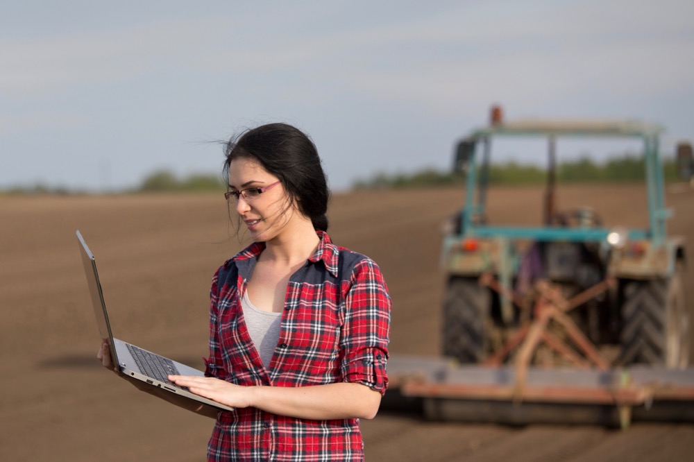 farmer with laptop in field