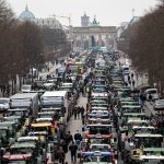 Demonstrating farmers with tractors pack a street near the Brandenburg gate in Berlin.