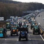 Tractors drive down a highway near Paris, France.