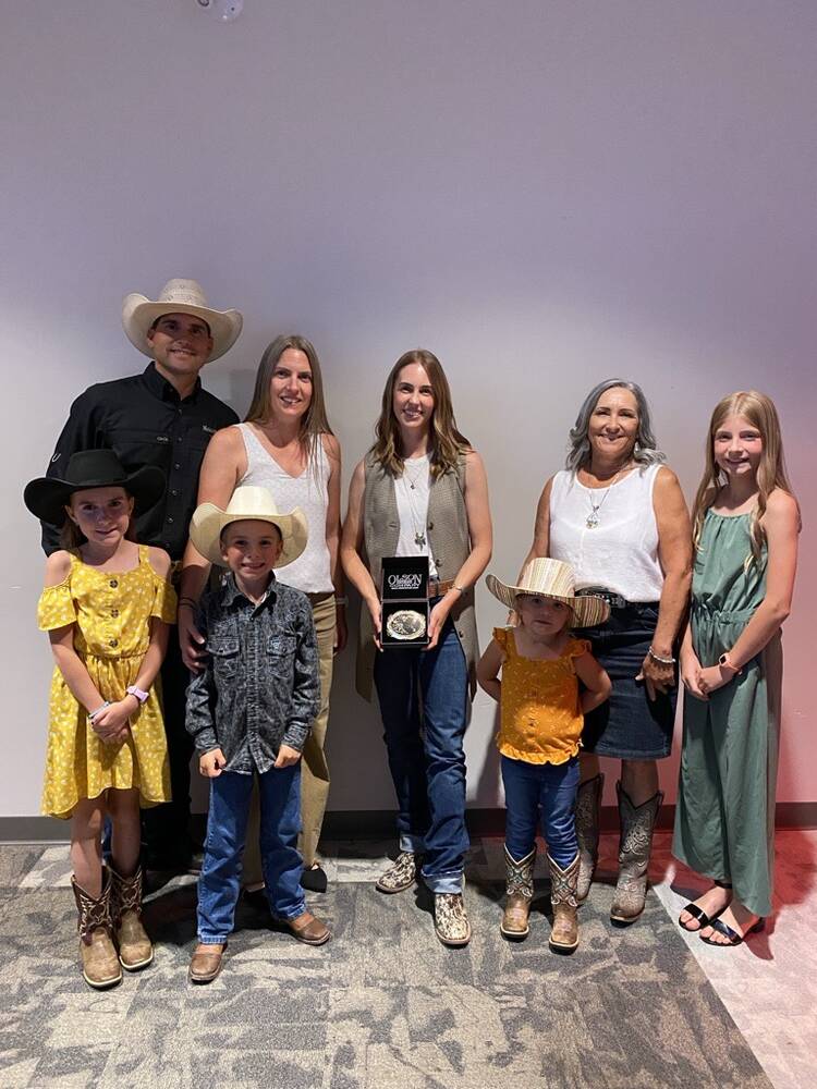 Cassie Marchand poses with the family of the late Reg Schellenberg