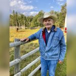 man in a cowboy hat on a ranch