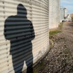 shadow of a man on a grain bin