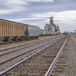 Grain elevators and train on the prairie.