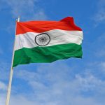 Indian flag waving in blue sky