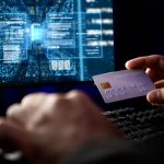 Cropped hands image in criminal anonymous male approaching credit card