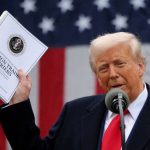 Donald Trump holds up documents on "liberation day"