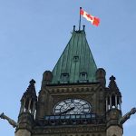 A Canadian flag flies at the top of one of the Parliament buildings in Ottawa.