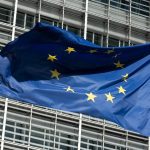 A European Union flag flies in the wind in front of the Berlaymont building, the seat of the European Commission, in Brussels.