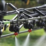 Close up of crop sprayer boom spraying.