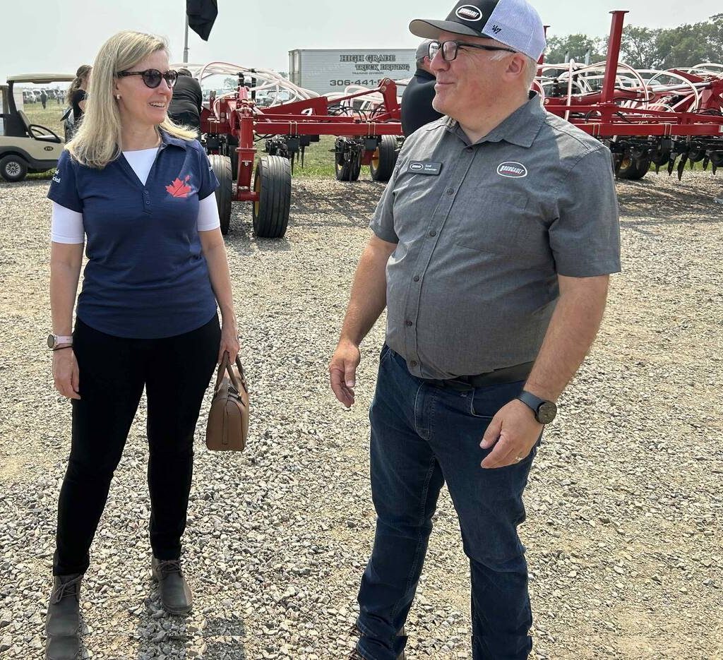 Canadian Chief Trade Commissioner Sara Wilshaw speaks with Scott Scherman of Bourgault industries at Ag In Motion 2025, near Langham, Sask. PHOTO: GORD GILMOUR