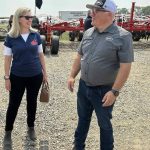 Canadian Chief Trade Commissioner Sara Wilshaw speaks with Scott Scherman of Bourgault industries at Ag In Motion 2025, near Langham, Sask. PHOTO: GORD GILMOUR
