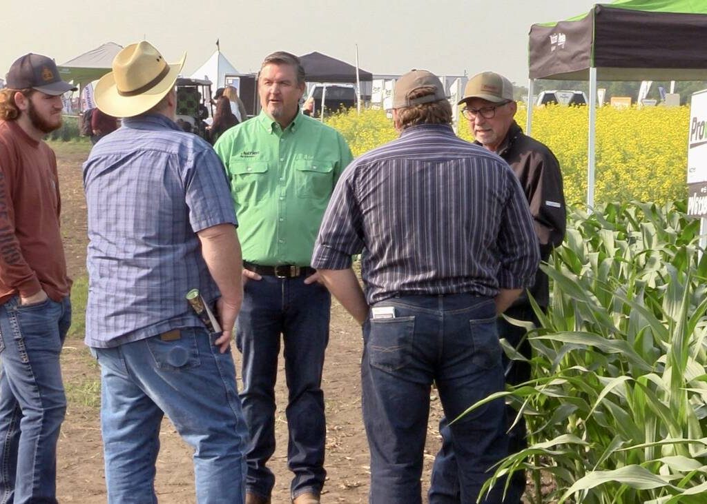Spencer Harris (green shirt) speaks with attendees at the Nutrien Ag Solutions crop plots at Ag in Motion on July 16, 2025. Photo: Greg Berg