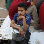 A charity distributes meals to Palestinians facing food shortages amid ongoing Israeli attacks and severe restrictions in Gaza City, Gaza on July 28, 2025.