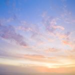 Sunset sky with fluffy clouds.