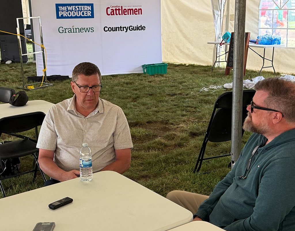 Scott Moe, left, talks to Western Producer reporter Sean Pratt at the Ag in Motion farm show near Langham, Saskatchewan.