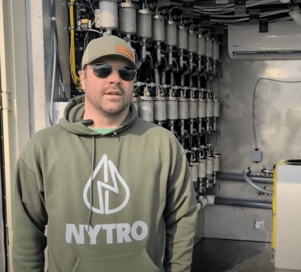 Chris Nykolaishen of Nytro Ag Corp stands outside his booth at Ag in Motion 2025.