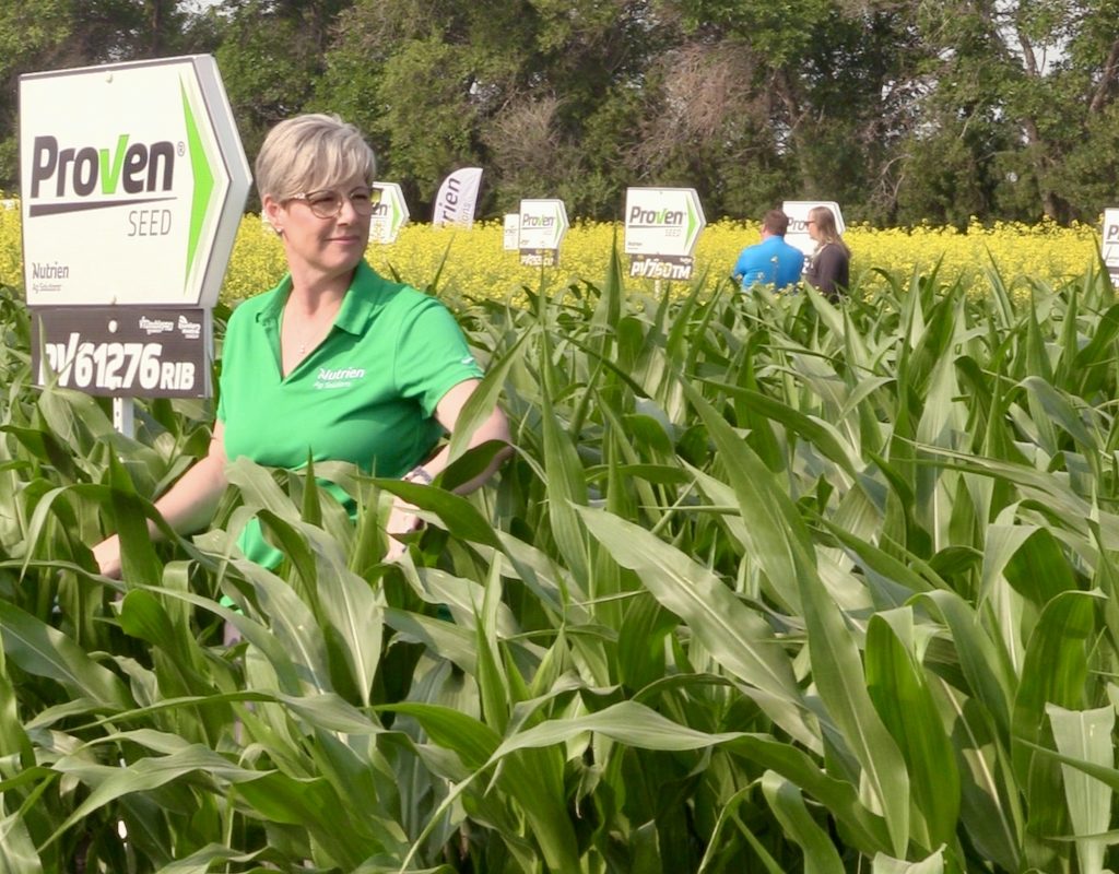 woman standing in a corn field at Ag in Motion