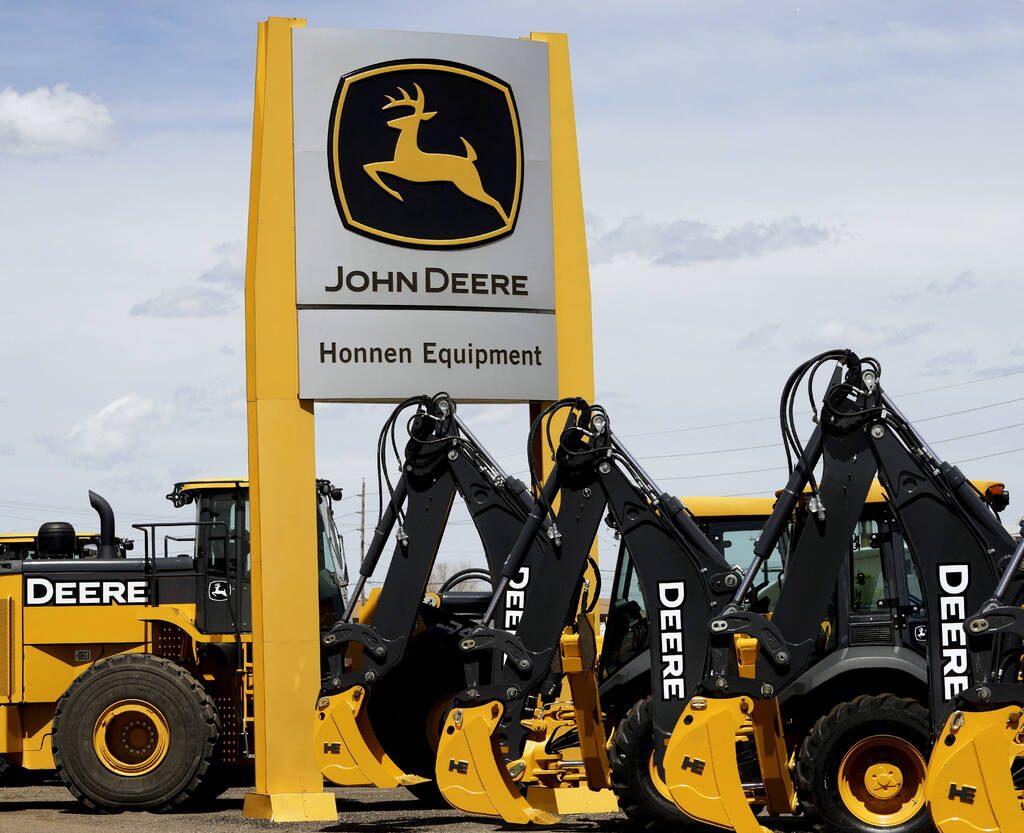 FILE PHOTO: Equipment for sale is seen at a John Deere dealer in Denver May 14, 2015. A weak global agriculture sector weighed heavily on quarterly results posted by Deere & Co on May 22, 2015, but earnings still topped expectations, and the farm equipment maker raised its full-year profit forecast despite a worsening sales outlook. Photo taken May 14, 2015.  REUTERS/Rick Wilking/File Photo