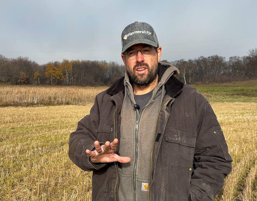 Farmer Scott Mowbray stands in a field on his farm, where despite extreme weather in recent years he is still able to grow crops, in Cartwright, Manitoba, Canada, October 23, 2025.