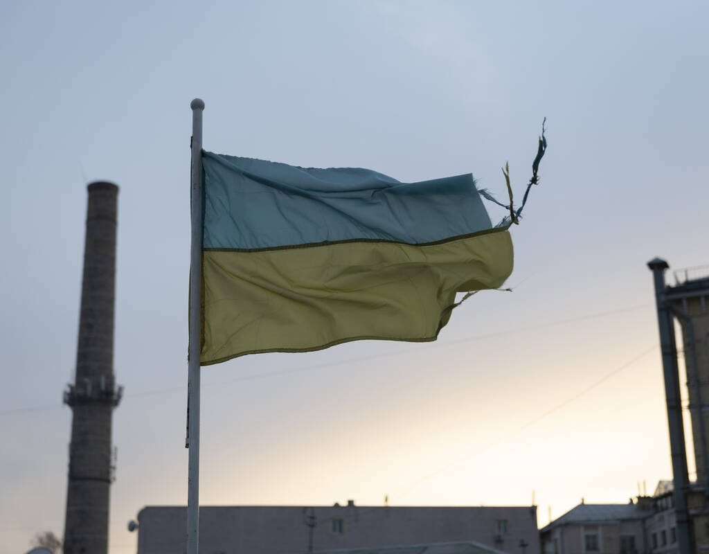 A weathered Ukrainian flag flies in the Podil district of Kyiv, Ukraine. Photo: Getty Images Plus.