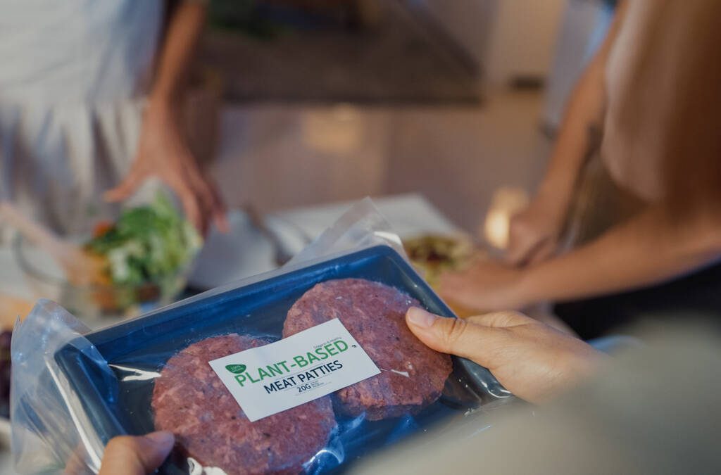 A person looks at a package of burger patties.