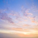 Aerial view of a sunset sky with clouds.