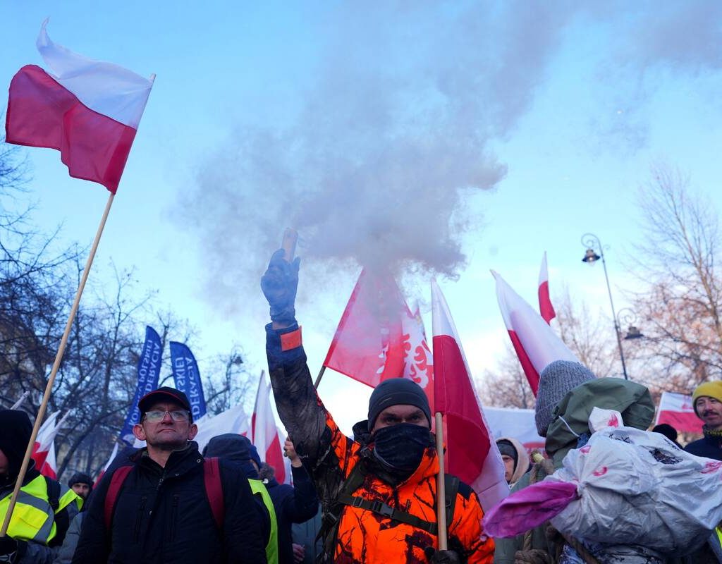 A demonstrator holds a flare as Polish farmers protest against the Mercosur trade deal in front of the Chancellery of the Prime Minister, in Warsaw, Poland, January 9, 2026.