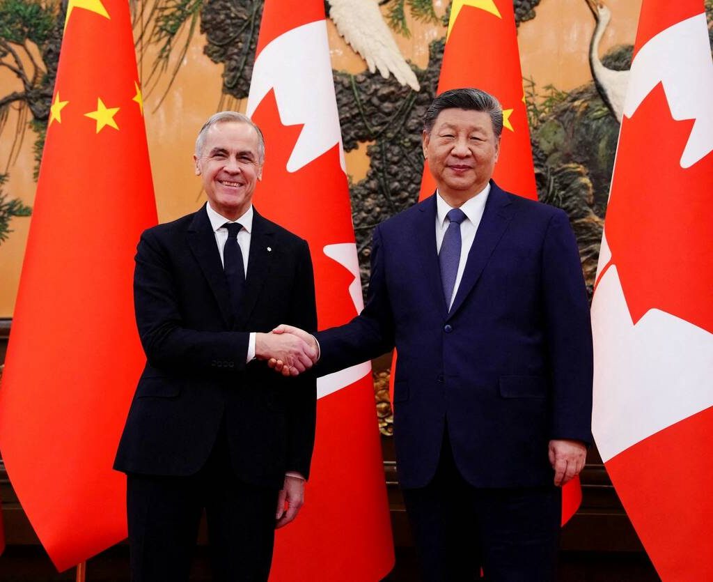 Canadian Prime Minister Mark Carney shakes hands with President of China Xi Jinping at the Great Hall of the People in Beijing, China on Friday, Jan. 16, 2026.