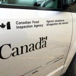 A close up on a CFIA logo on a vehicle door.