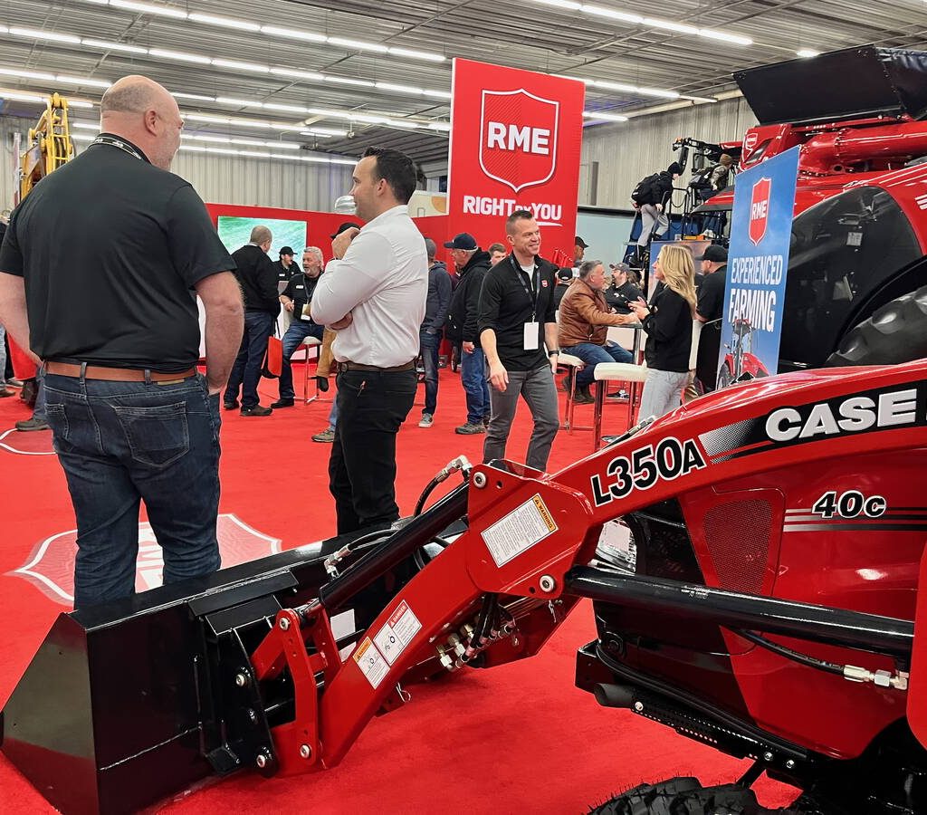 Red signs mixed with red combines, red tractors, red equipment on a red carpet makes the Rocky Mountain Equipment booth hard to miss at Manitoba Ag Days 2026 in Brandon. Photo: Alexis Stockford