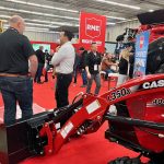 Red signs mixed with red combines, red tractors, red equipment on a red carpet makes the Rocky Mountain Equipment booth hard to miss at Manitoba Ag Days 2026 in Brandon. Photo: Alexis Stockford