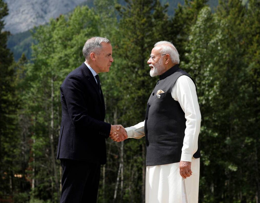 Canadian Prime Minister Mark Carney and India's Prime Minister Narendra Modi shake hands before posing for a photo during the G7 Leaders' Summit in Kananaskis, in Alberta, Canada, June 17, 2025.