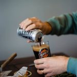 Hands pour beer from a can of Farmery Estate Brewery beer. Photo: Facebook/Farmery Estate Brewery