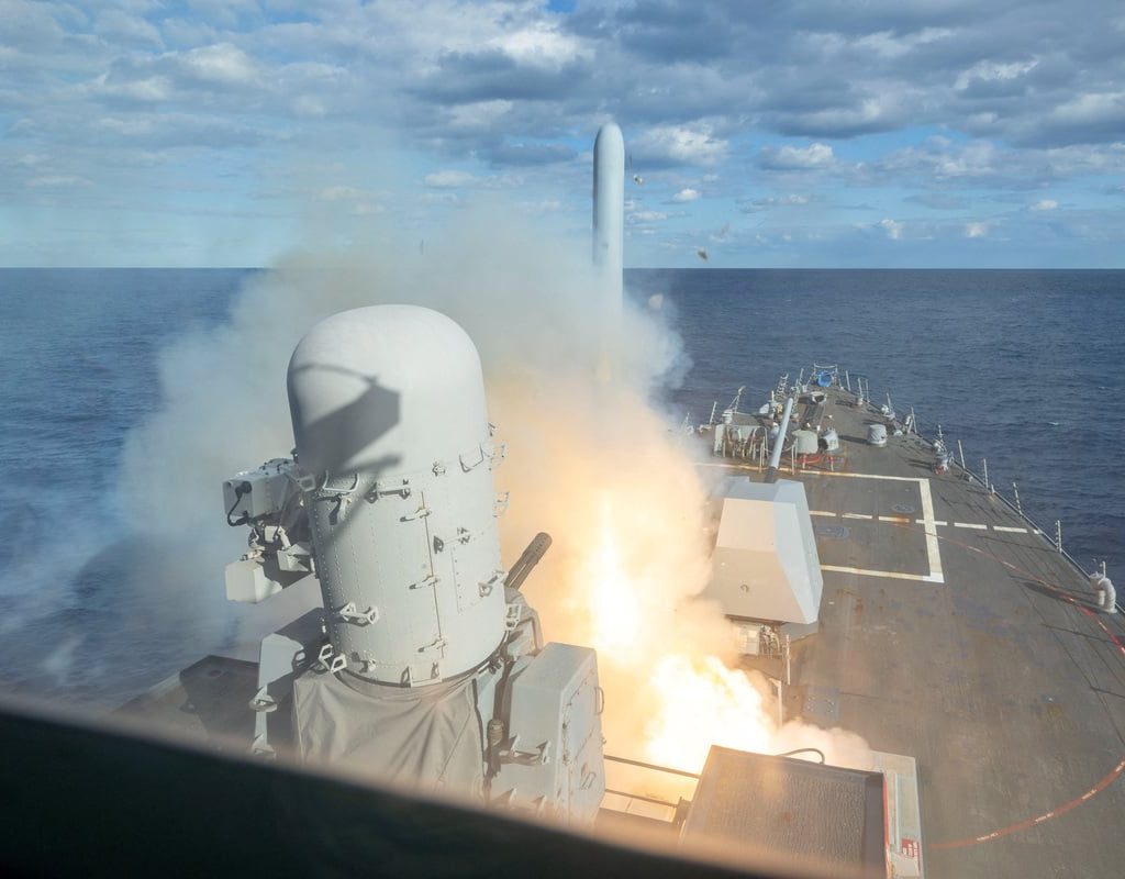 A missile is seen launching from the deck of a ship.