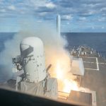 A missile is seen launching from the deck of a ship.