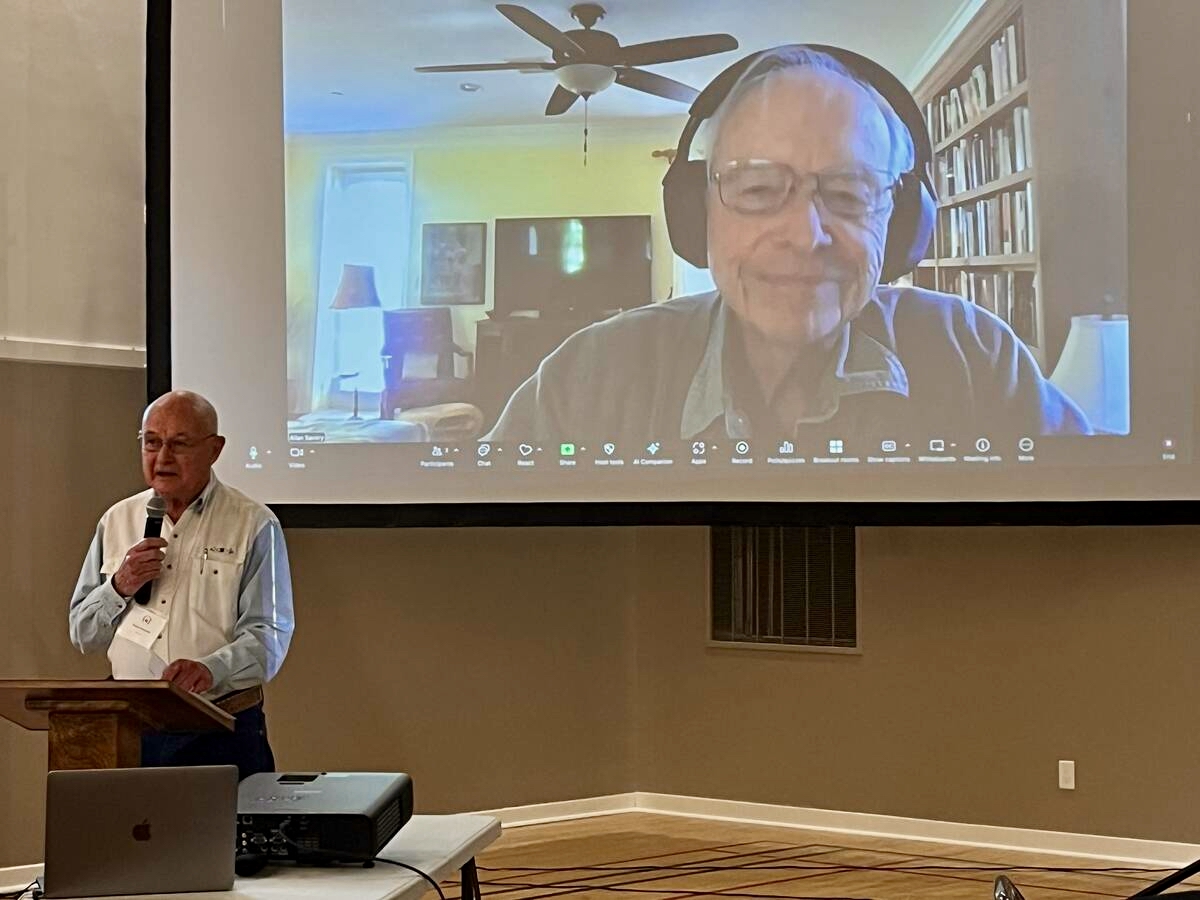 Blake Holtman talking with Allan Savory via an online camera at the recent Holistic Management Conference in Taber, Alberta