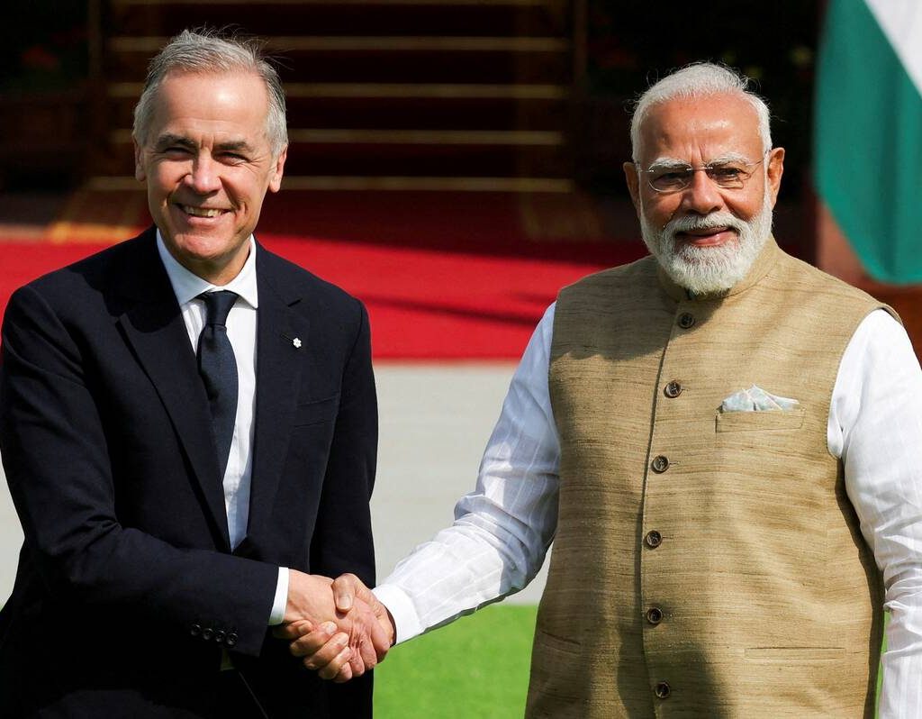 Canada's Prime Minister Mark Carney walks with his Indian counterpart, Narendra Modi, before their meeting at Hyderabad House in New Delhi, India,