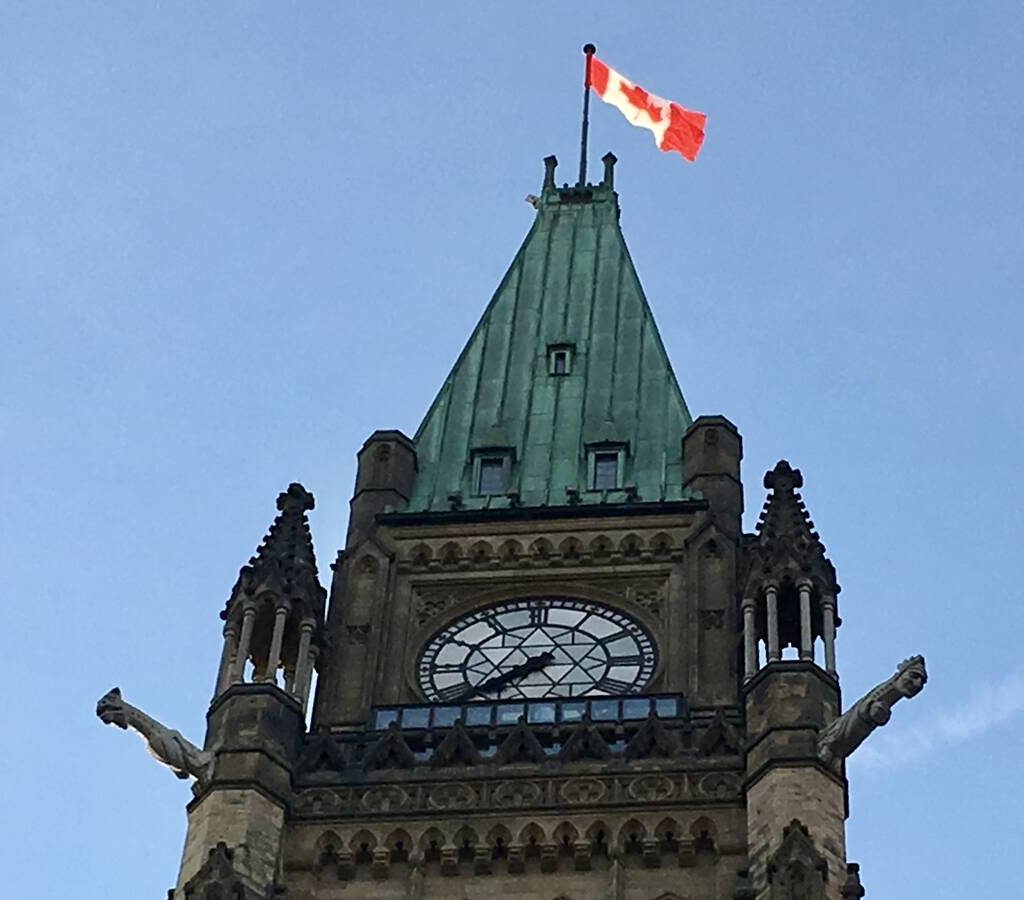 A Canadian flag flies at the top of one of the Parliament buildings in Ottawa. Photo: File